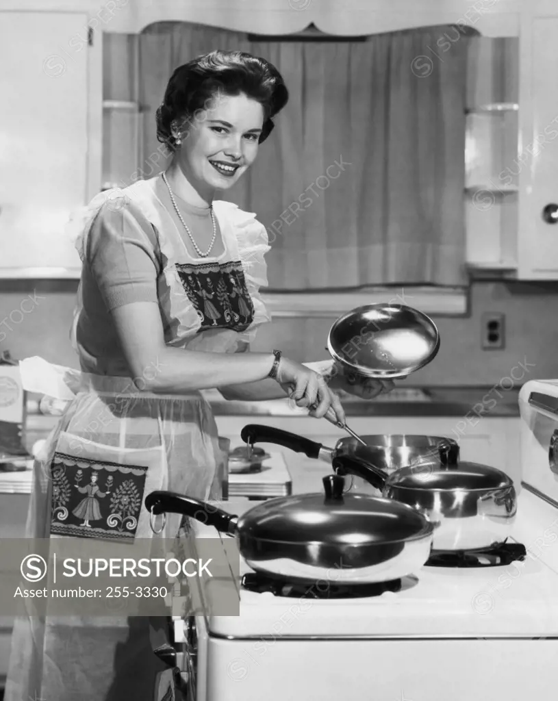 Portrait of a young woman preparing food in the kitchen