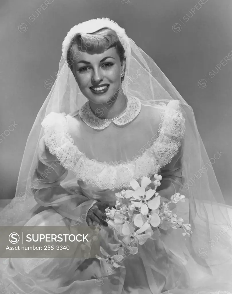 Portrait of a bride holding flowers and smiling