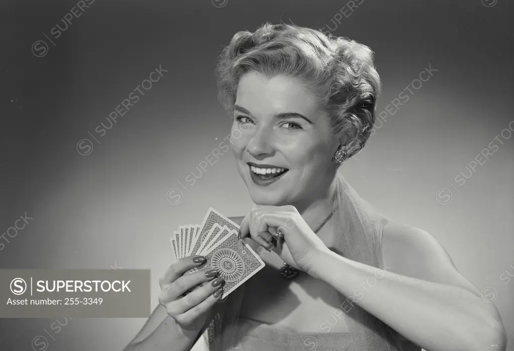 Vintage Photograph. Woman in lace dress holding hand of cards