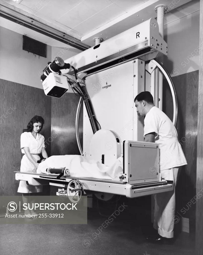 Two radiologists taking an x-ray of a patient