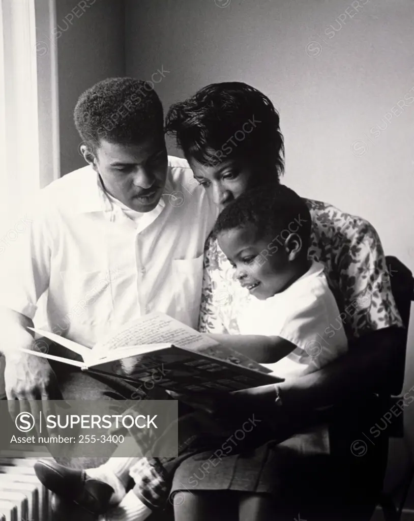 Parents reading to their son