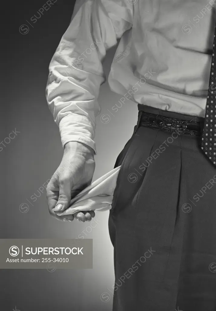 Vintage photograph. Close view of man turning out empty pants pocket
