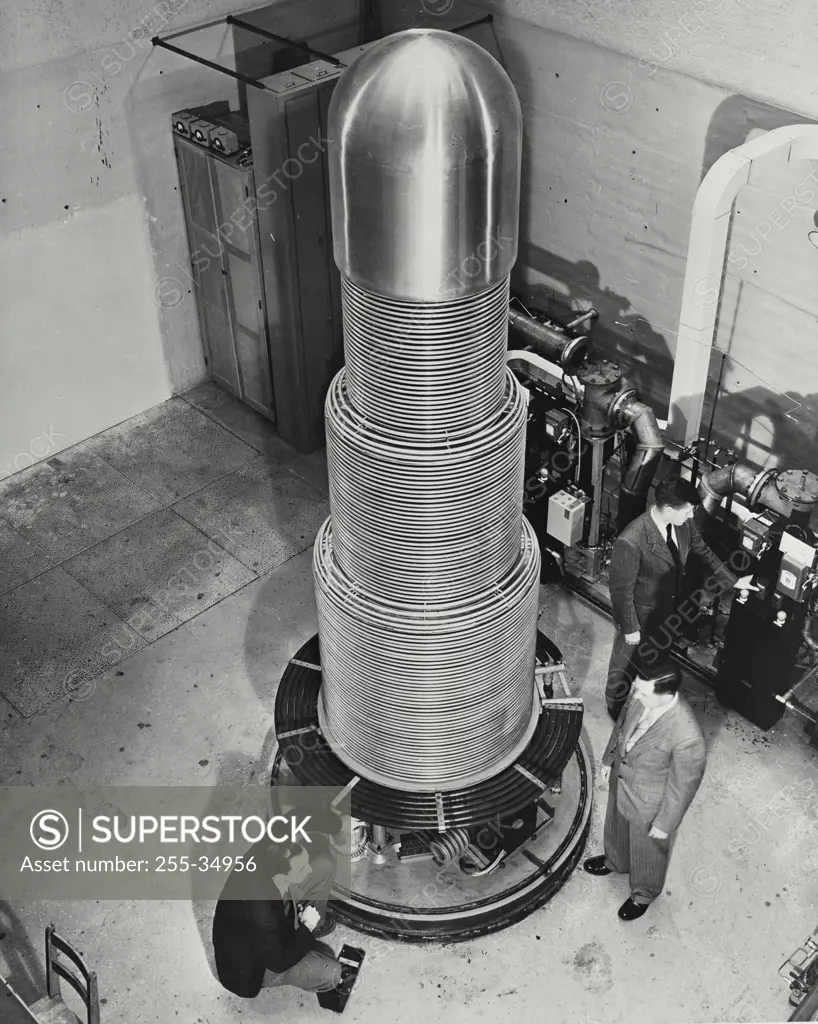 Vintage photograph. Three scientist inspecting a Van De Graaff Static Electricity Generator, Chalk River Laboratories, Chalk River, Ontario, Canada