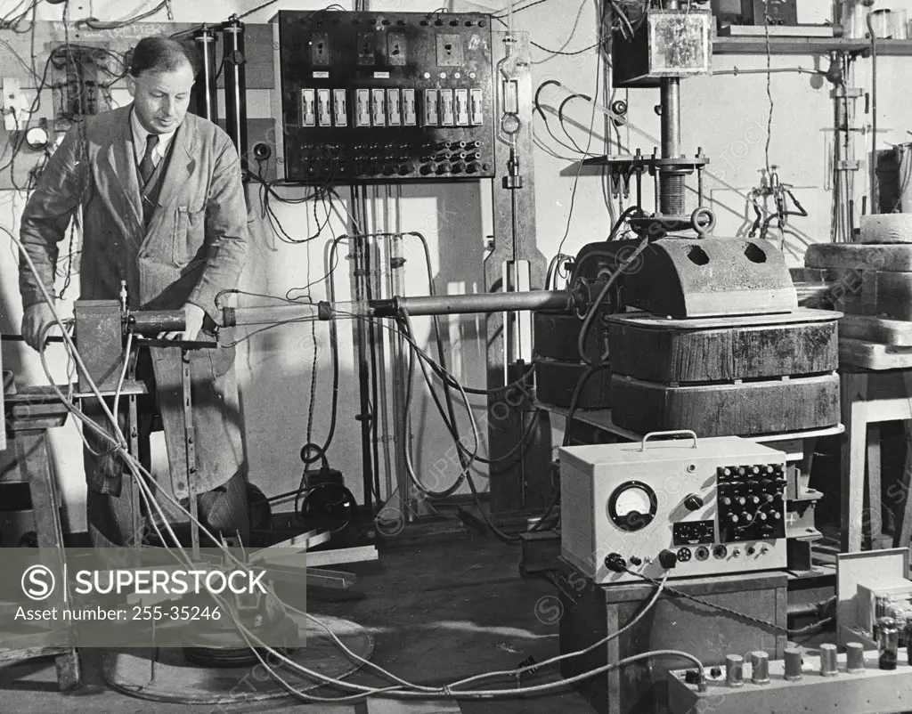 Vintage photograph. Scientist experimenting on artificial transmutation in a high voltage laboratory, Cavendish Laboratory, University Of Cambridge, England