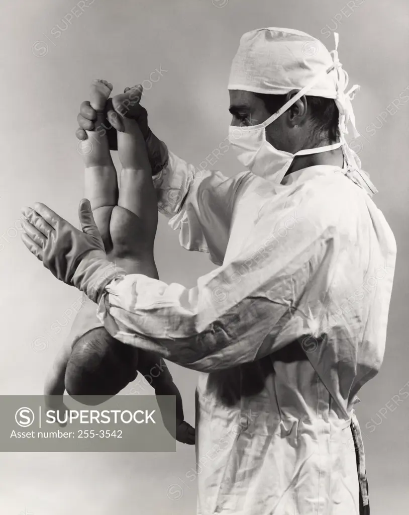 Male doctor spanking newborn baby