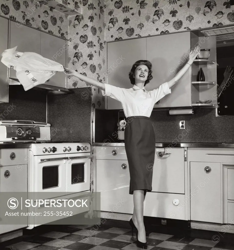 Young woman standing in the kitchen and smiling