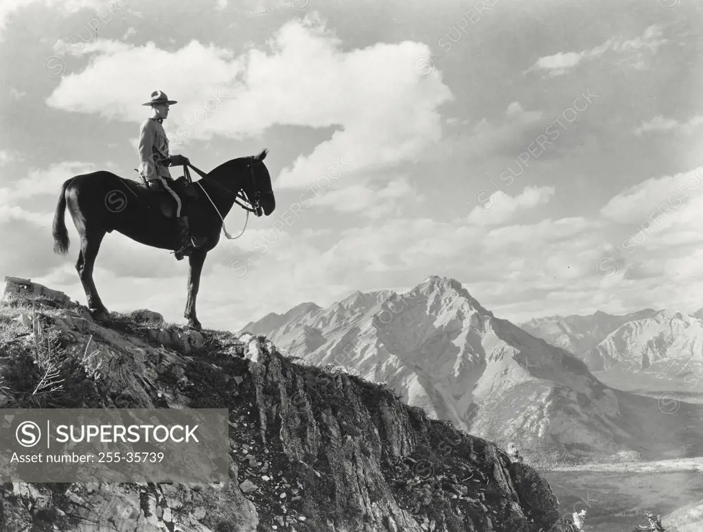 Vintage photograph. A Royal Canadian Mounted Police constable atop Sulphur Mountain in Banff National Park, Alberta, Canada
