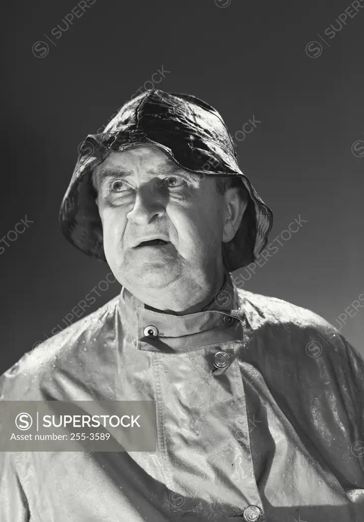 Vintage photograph. Man in rain hat and rain coat