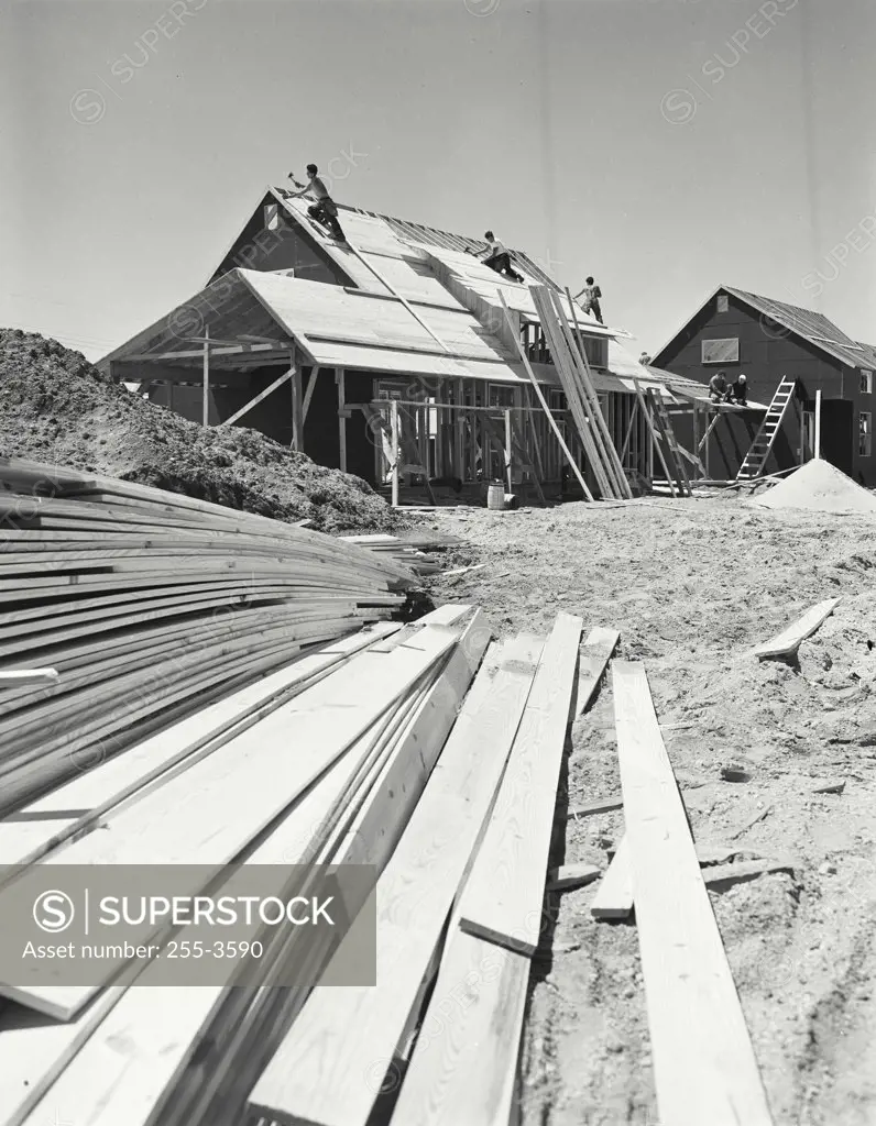 Vintage photograph. Scene in subdivision, houses under construction, roofing