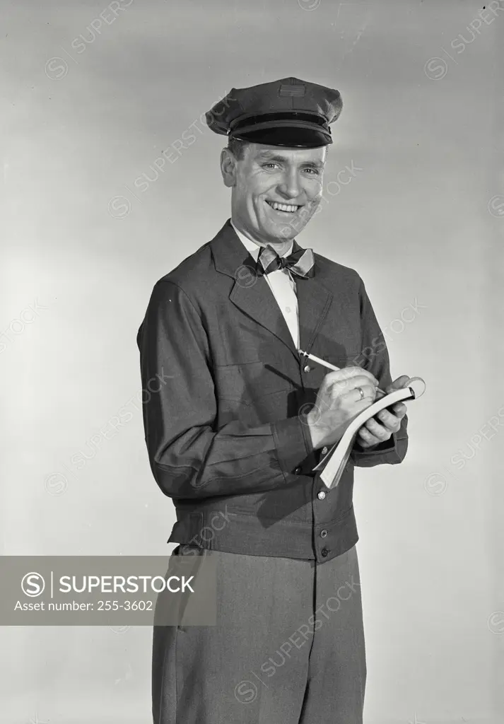 Vintage Photograph. Portrait of a delivery person writing on a note pad
