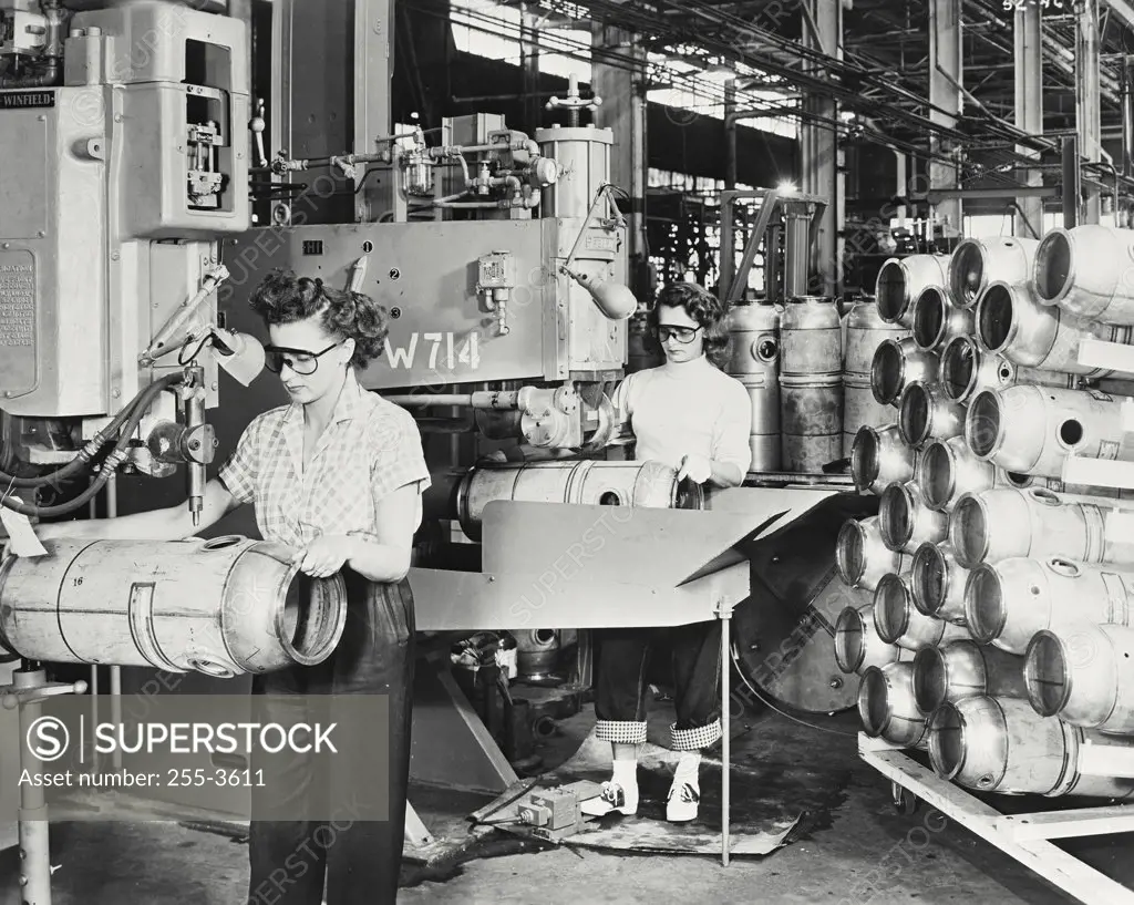 Vintage photograph. Two female workers welding combustion chambers of J47 Jet Engines with spot welding and seam welding in a factory