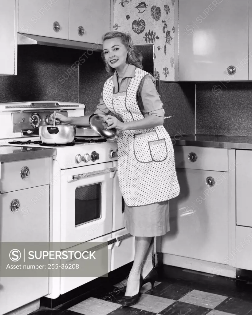 Young woman cooking in the kitchen and smiling
