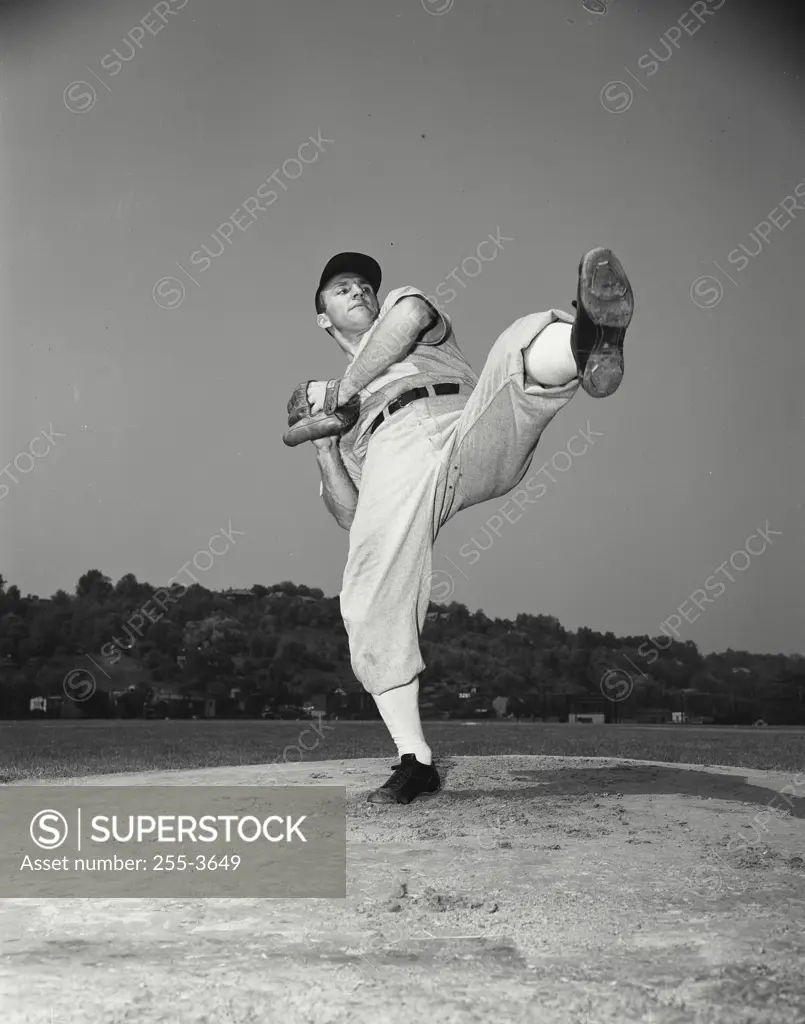 Vintage Photograph. Baseball pitcher leaning back to throw ball