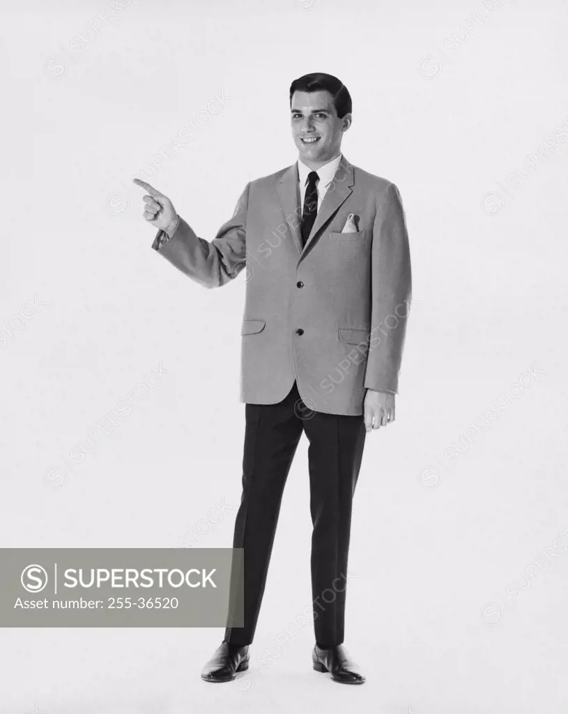 Portrait of a businessman pointing sideways
