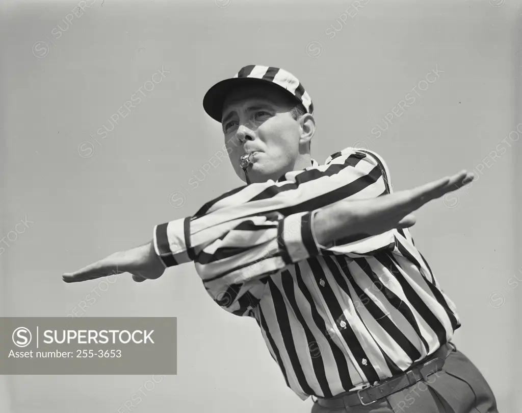Vintage photograph. Football ref making incomplete pass hand signal