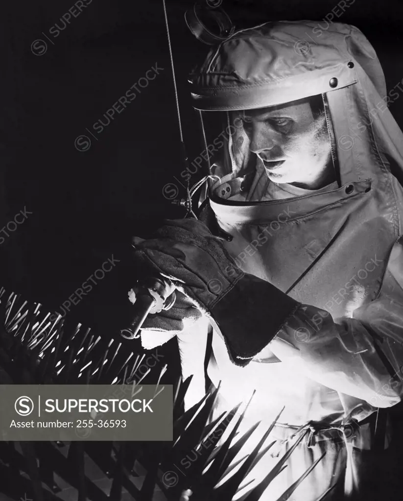 Close-up of a man cleaning surface dirt from an jet engine