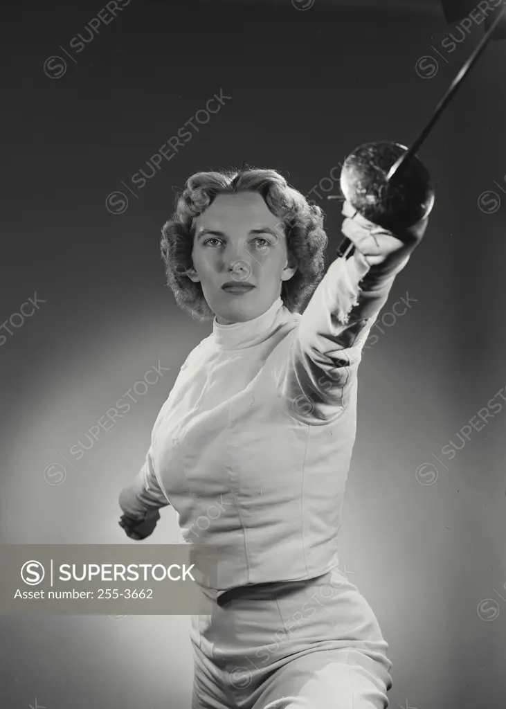 Vintage Photograph. Woman in fencing gear holding out saber in fighting stance. Frame 1