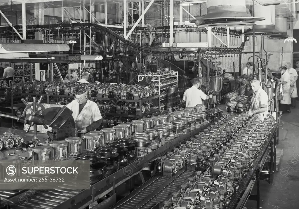 Vintage Photograph. Assembly of the household refrigerator compressors.