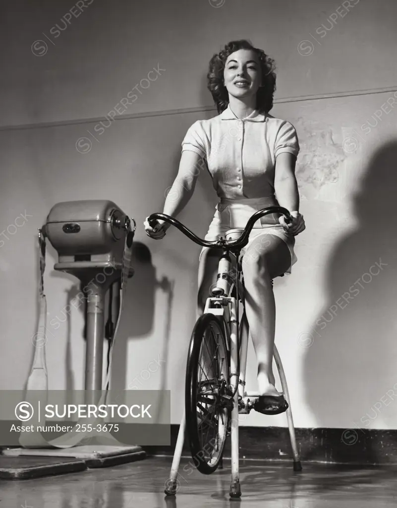 Young woman exercising on an exercise bike