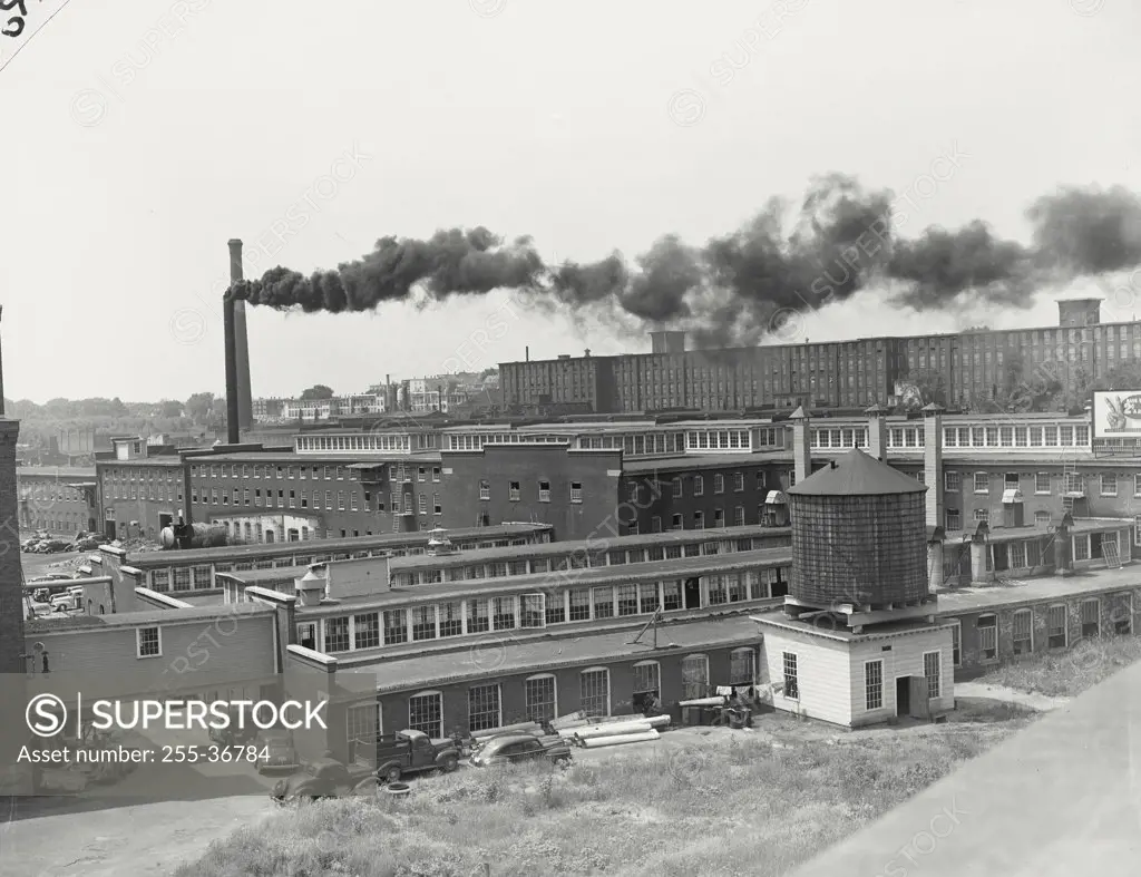 Vintage photograph. Smoke emitting from the smoke stack of a factory at Amoskeag Mills, Manchester, New Hampshire