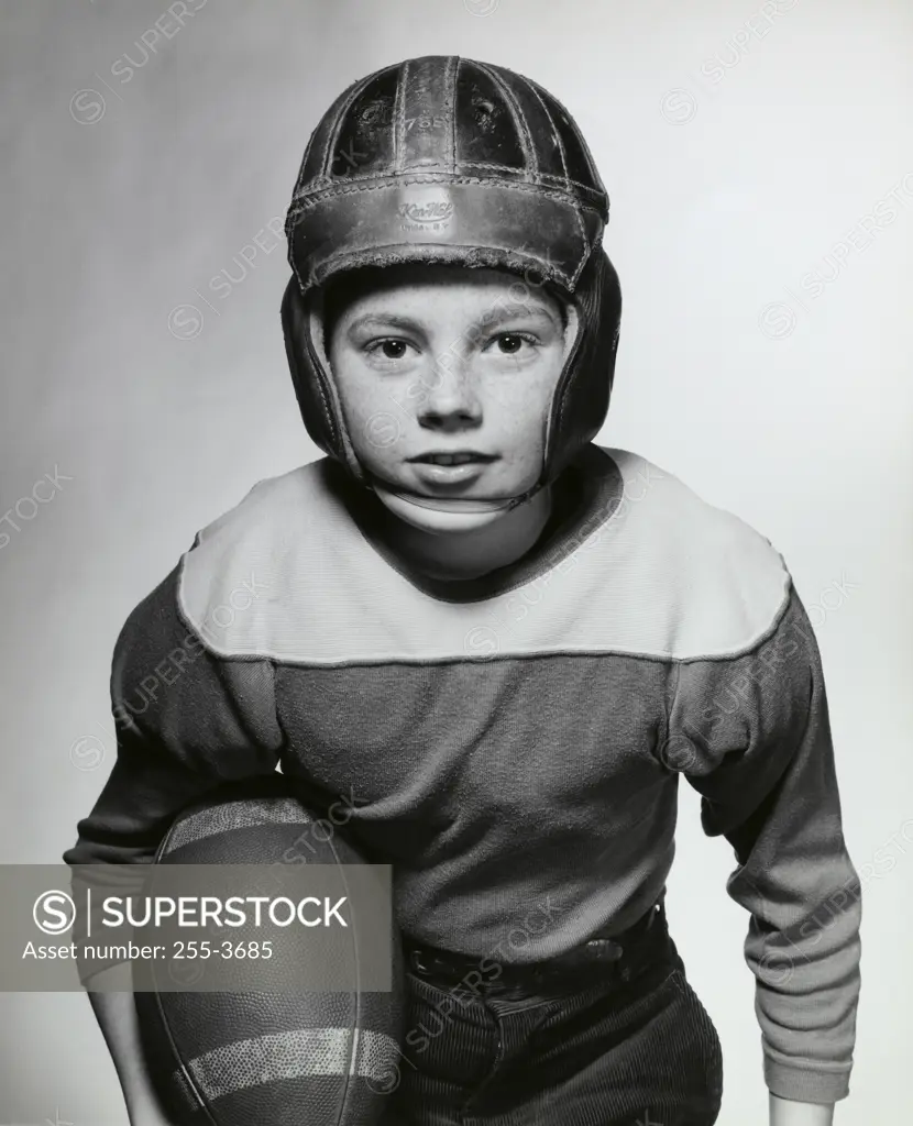 Close-up of a boy holding a football