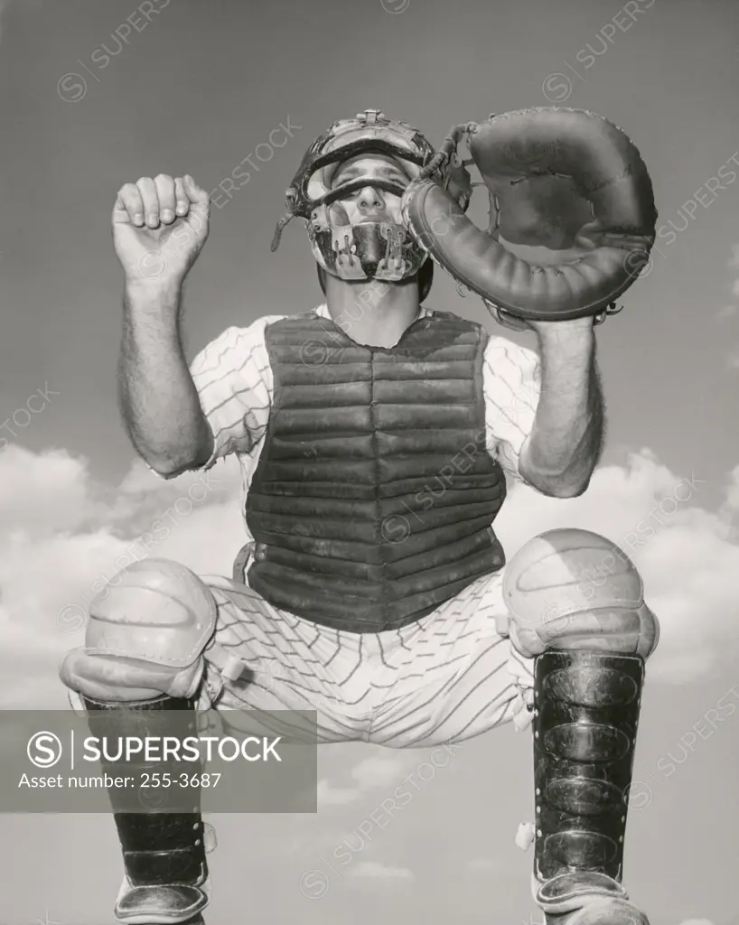 Close-up of a baseball catcher crouching