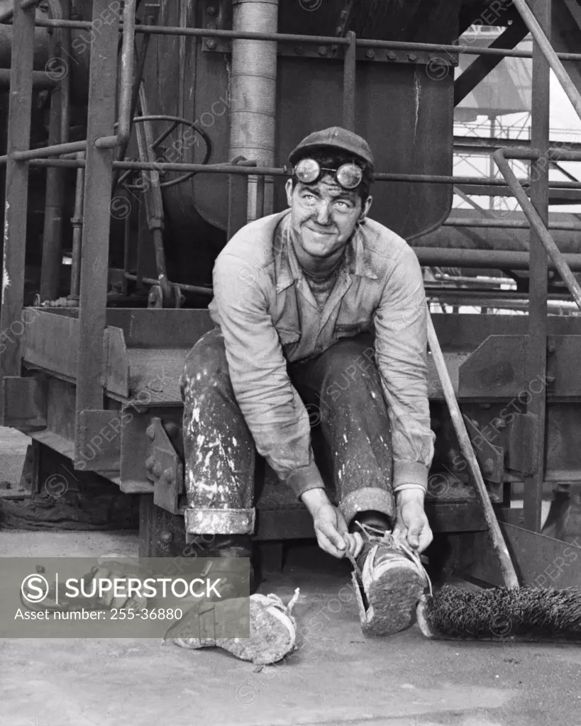 Manual worker putting on shoes, US Steel, Geneva, Utah, USA