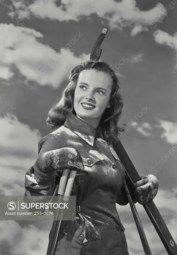 Vintage Photograph. Side profile of a young woman holding a ski