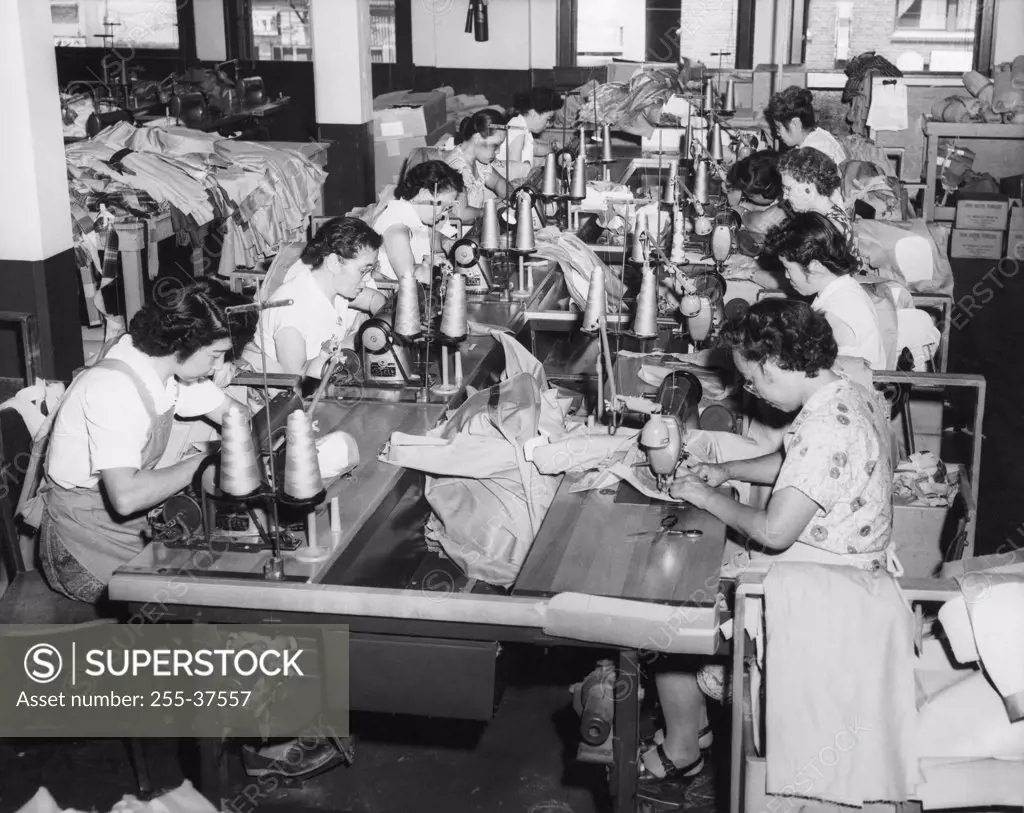 Side profile of a group of female workers in a textile factory