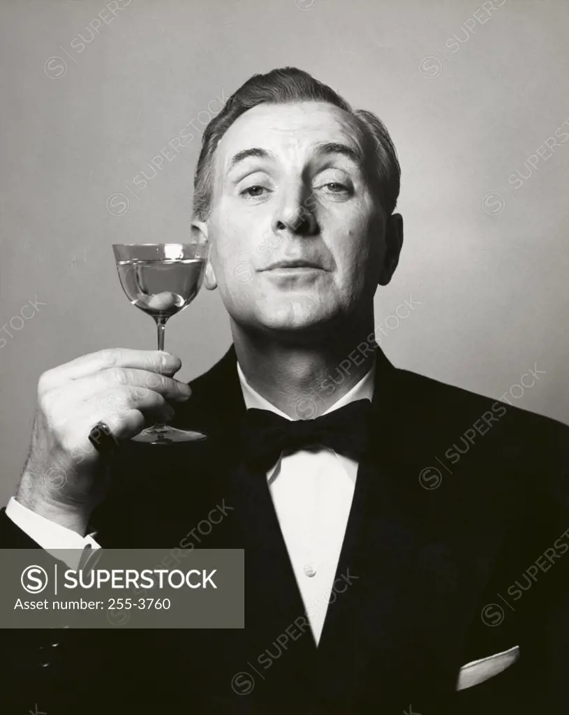 Portrait of a mature man holding a martini glass