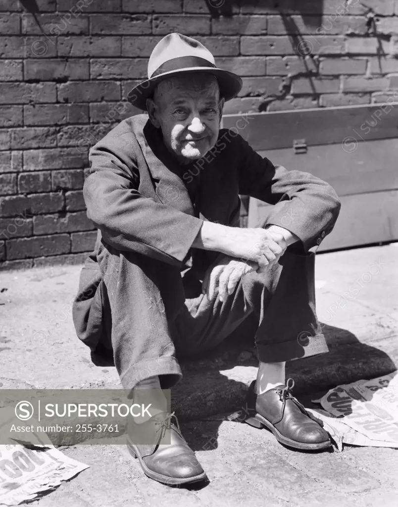 Portrait of a mature man sitting on the street