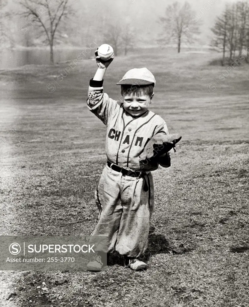 Portrait of a boy holding a baseball and a baseball glove