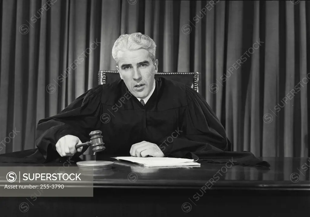Vintage photograph. Portrait of a judge holding a gavel