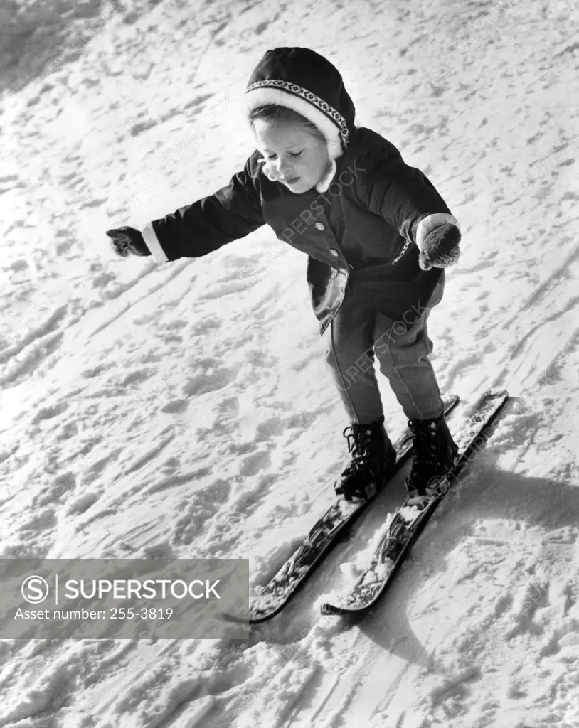 High angle view of a girl skiing on snow