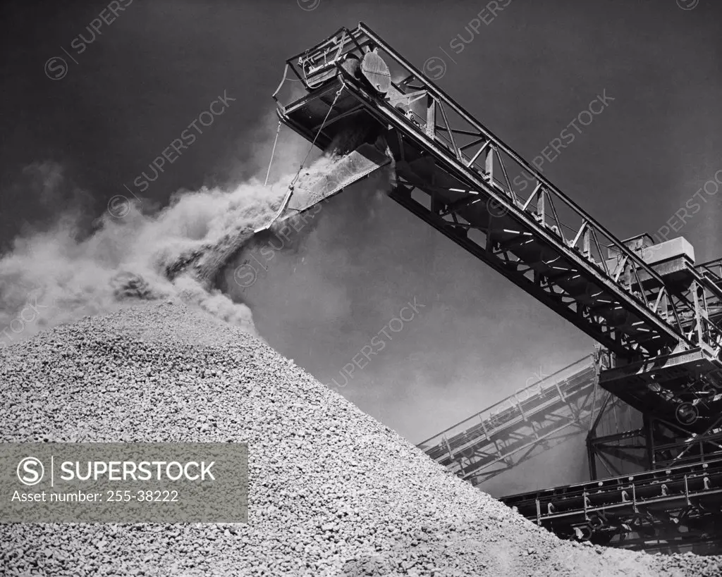 Low angle view of a conveyor belt unloading bauxite from a ship, Mobile, Alabama, USA
