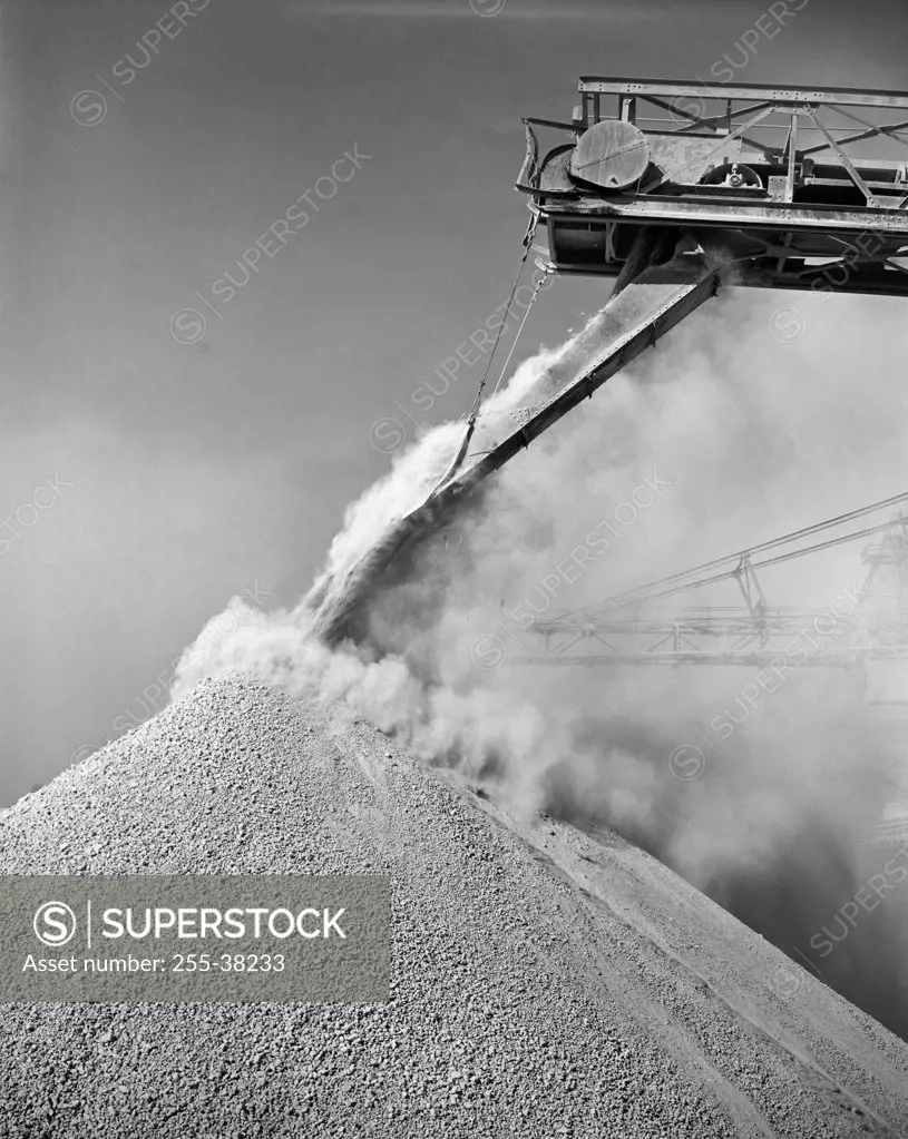 Low angle view of a conveyor belt unloading bauxite from a ship, Mobile, Alabama, USA