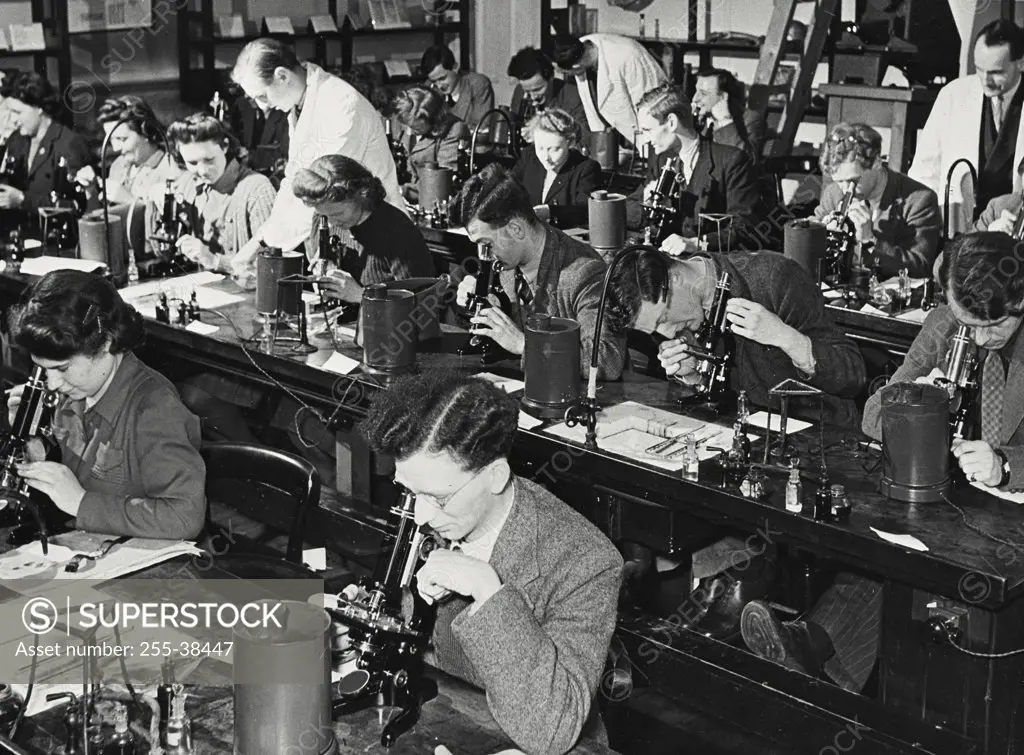 Vintage photograph. College students examining with microscope in a laboratory, Bacteriological Laboratory, Bristol University, Bristol, England