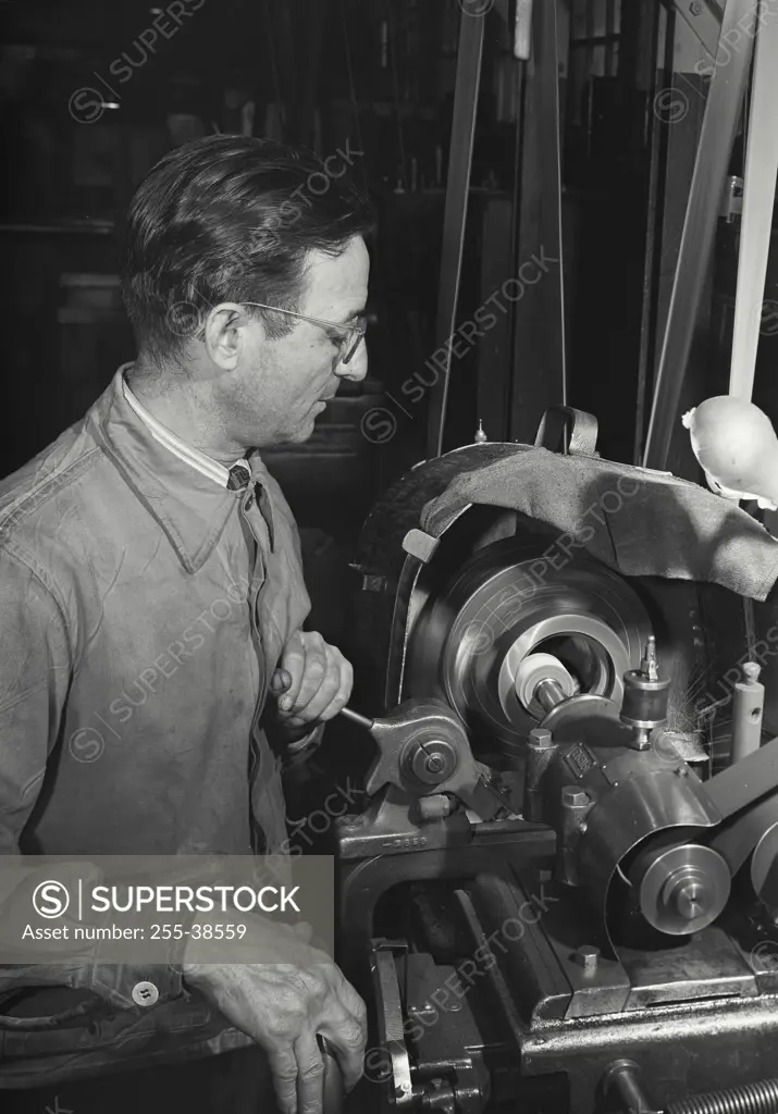 Vintage Photograph. Man operating an internal grinder machine at Worthington Pump and Machinery Corporation, Harrison, New Jersey