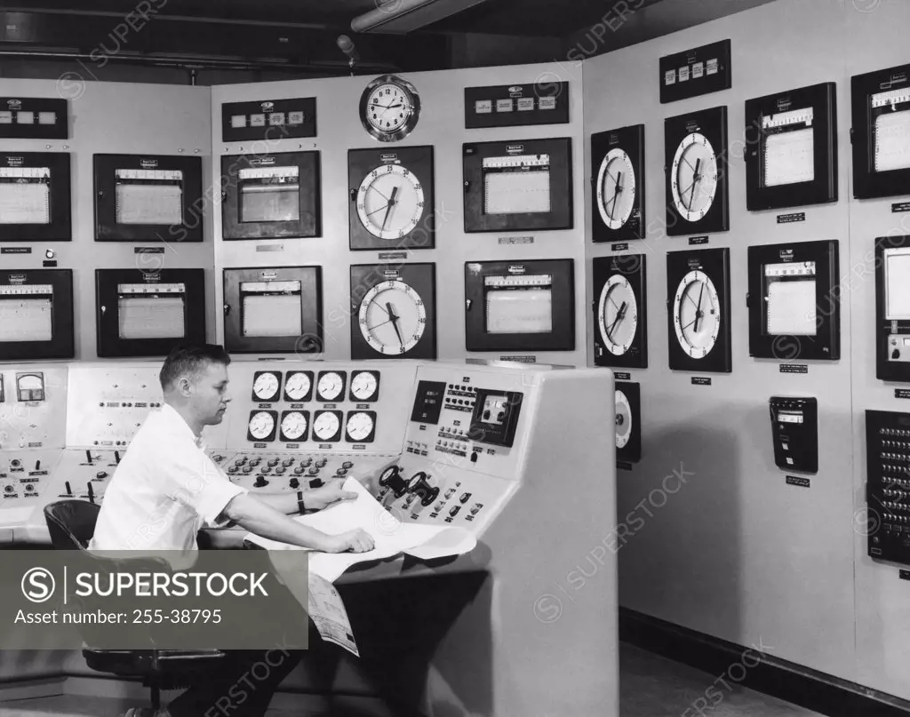 Technician sitting in a control room of a nuclear power station