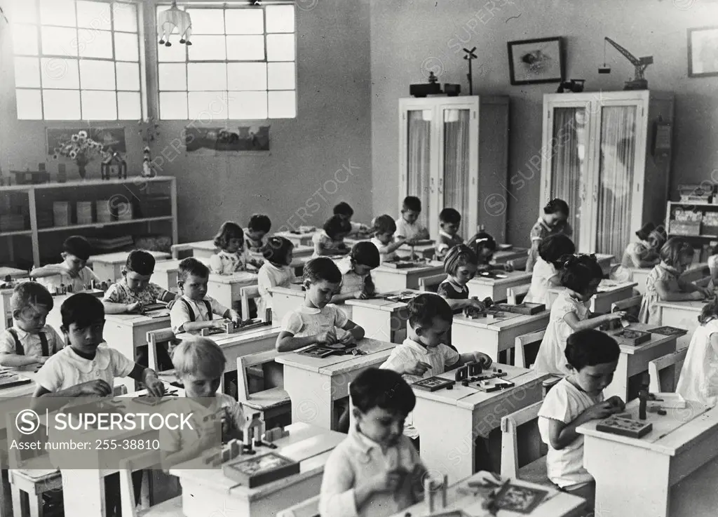 Vintage photograph. Group of school children in an arts and crafts class for white children in the Congo