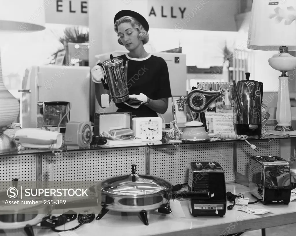 Woman inspecting households items in a store