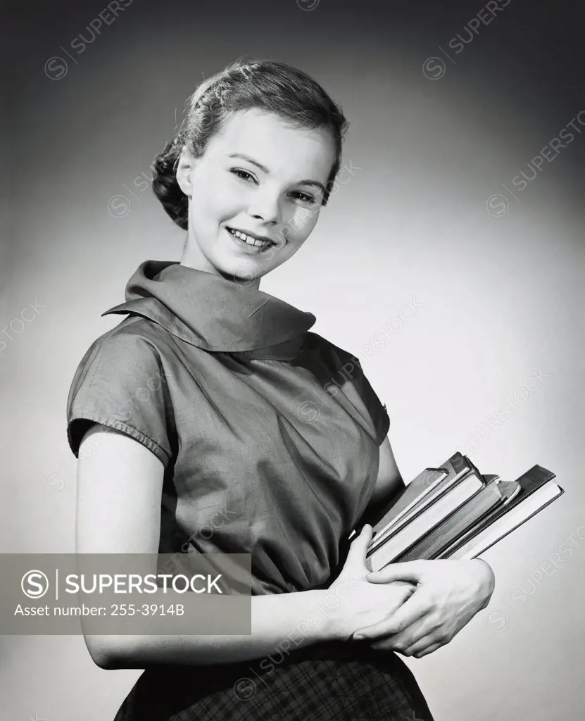 Teenage girl carrying books