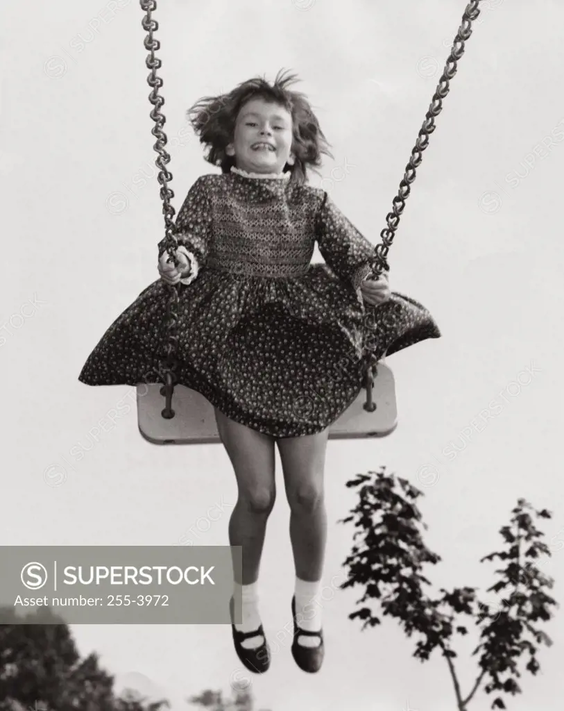 Low angle view of a girl on a swing