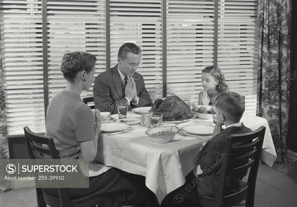 Vintage Photograph. Family at table praying before dinner. Frame 3