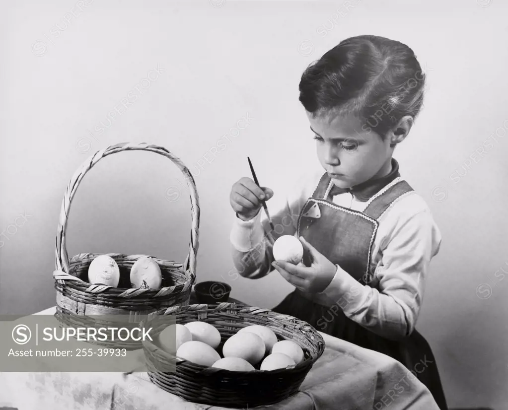 Girl painting an Easter egg