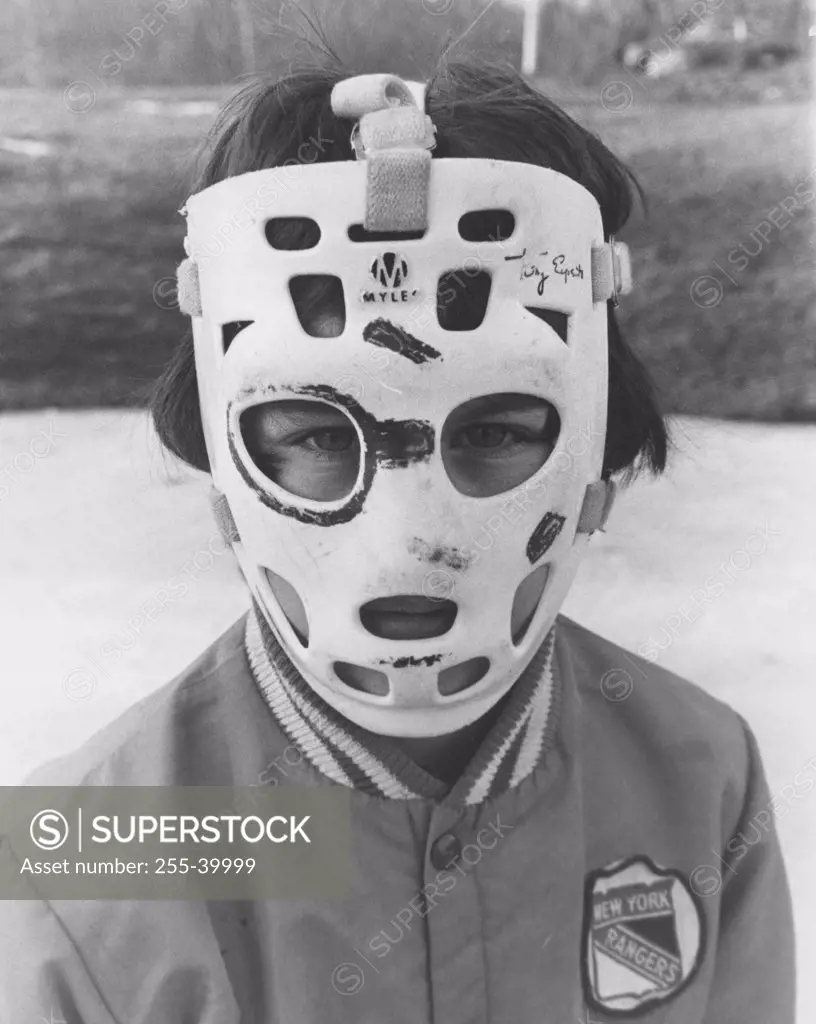 Portrait of a boy wearing a goalie mask on his face