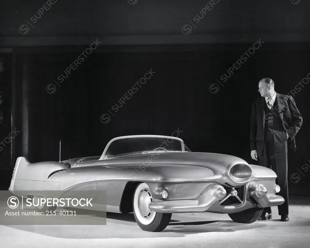 Mature man looking at a convertible car, 1950's Buick LeSabre prototype
