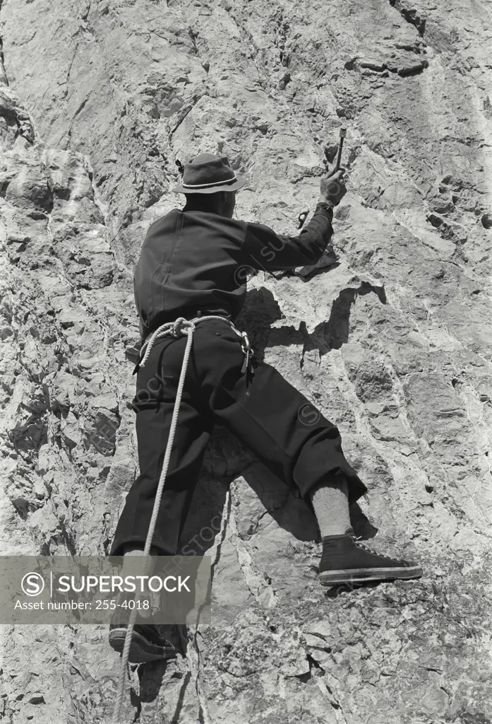 Vintage Photograph. Rear view of a man climbing on a mountain, Jackson Hole, Wyoming, USA