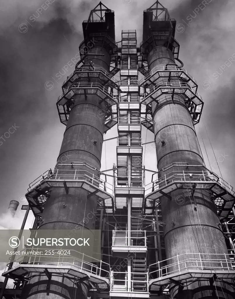 Low angle view of two smoke stacks of a factory