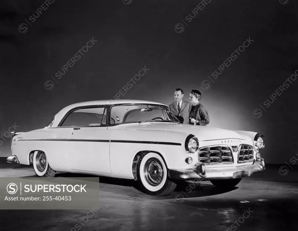 Couple standing near a 1955 Chrysler 300